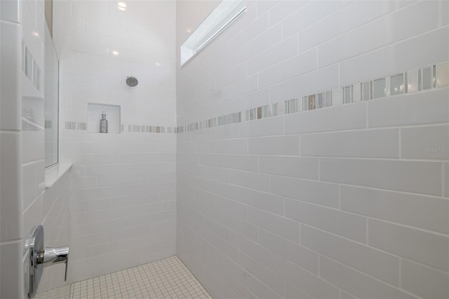 bathroom with a tile shower