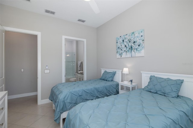 bedroom featuring light tile patterned floors, baseboards, visible vents, and ensuite bathroom