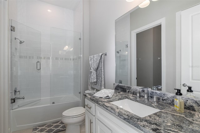 bathroom featuring bathing tub / shower combination, vanity, and toilet