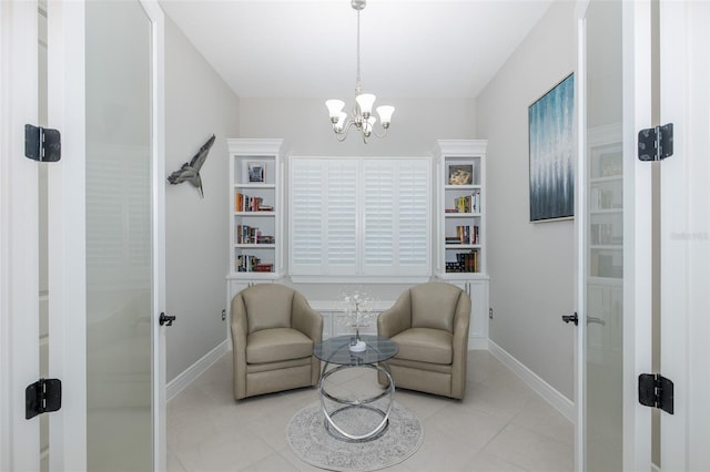 living area with a chandelier, light tile patterned flooring, and baseboards