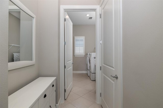 bathroom with tile patterned flooring, visible vents, washer and clothes dryer, and baseboards