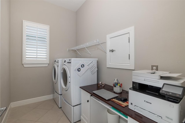 washroom with light tile patterned floors, laundry area, separate washer and dryer, and baseboards