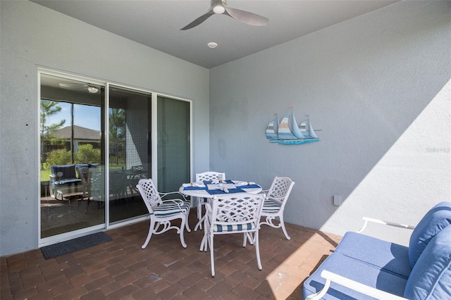 view of patio / terrace with outdoor dining area and a ceiling fan