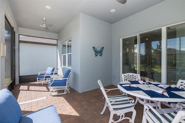 exterior space with outdoor dining space and a ceiling fan