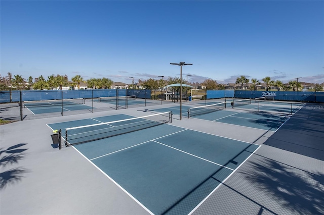 view of tennis court featuring fence