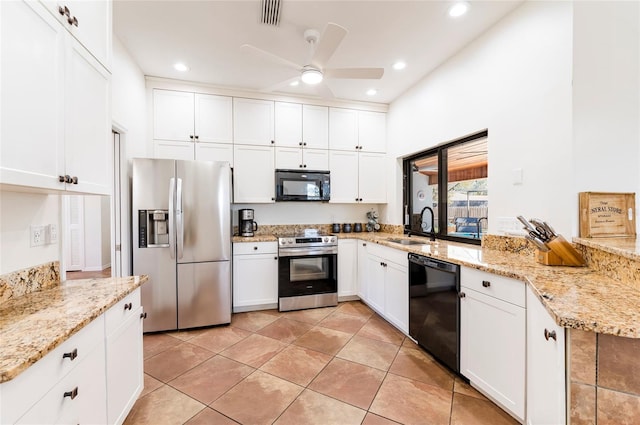 kitchen featuring visible vents, black appliances, a sink, light stone counters, and white cabinetry