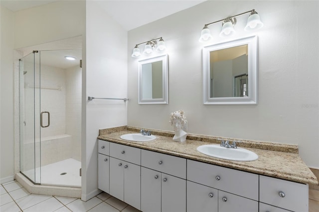 full bathroom with a sink, a stall shower, and double vanity