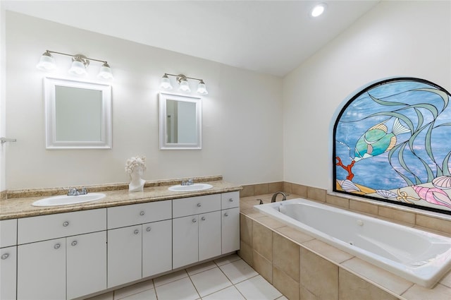 bathroom featuring double vanity, tile patterned floors, a bath, and a sink