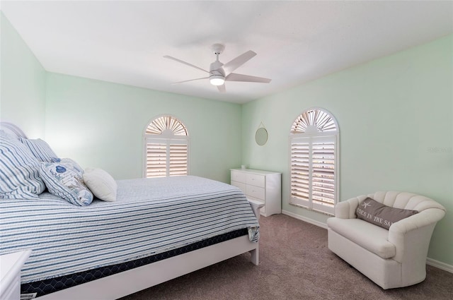 bedroom featuring ceiling fan, baseboards, and carpet