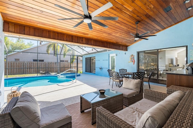 view of pool with outdoor dining space, fence, glass enclosure, an outdoor hangout area, and a patio area