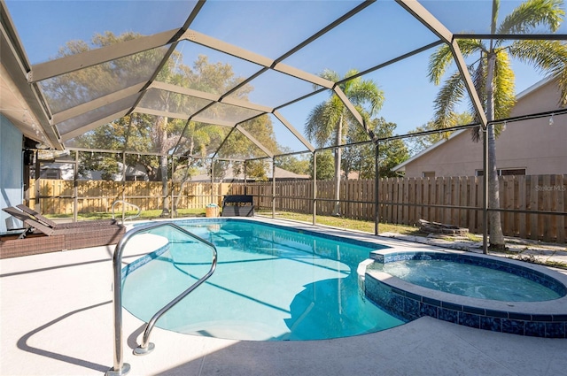 view of pool with a patio area, a lanai, a pool with connected hot tub, and a fenced backyard