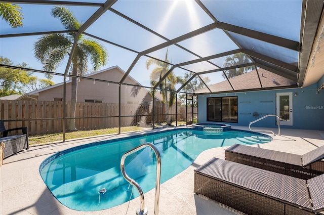 view of pool featuring glass enclosure, a patio, fence, and a pool with connected hot tub