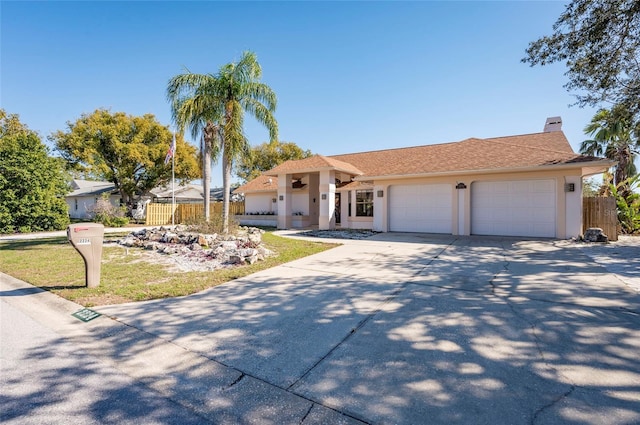 ranch-style house with stucco siding, concrete driveway, a garage, and fence