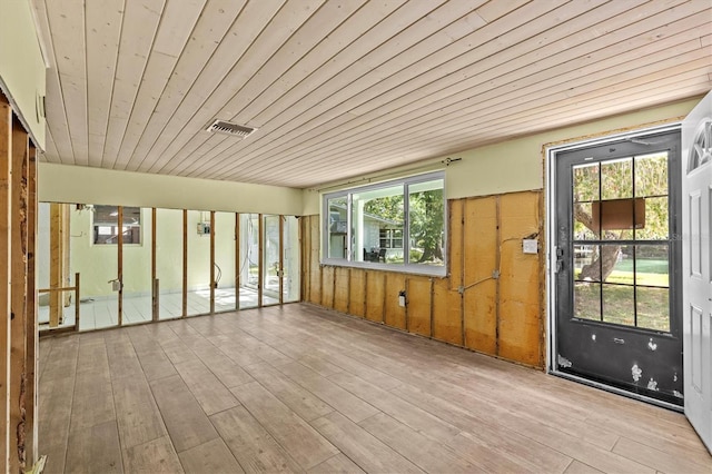 unfurnished sunroom featuring visible vents