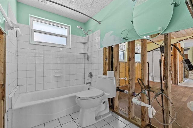full bath featuring shower / bath combination, a textured ceiling, tile patterned flooring, and toilet