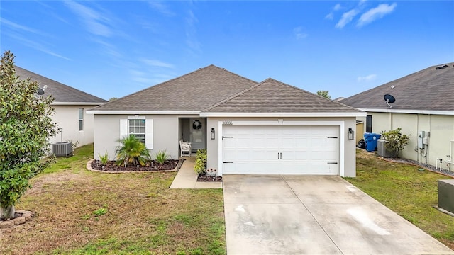 ranch-style home with stucco siding, concrete driveway, a front yard, a shingled roof, and a garage