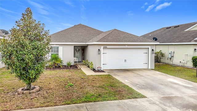 ranch-style home featuring a front yard, roof with shingles, an attached garage, stucco siding, and concrete driveway