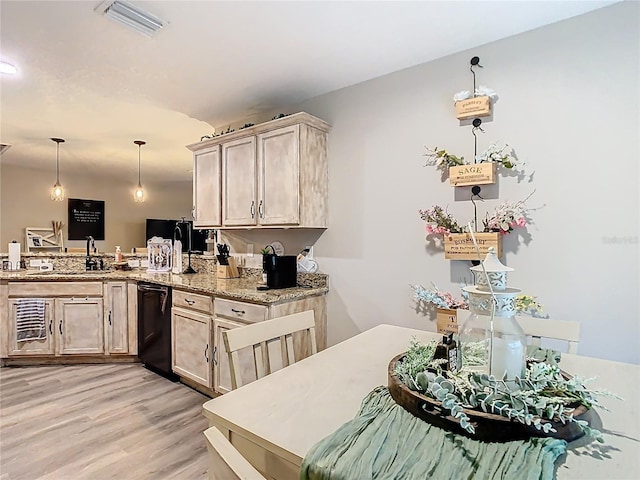 kitchen featuring light wood-type flooring, visible vents, a sink, black dishwasher, and a peninsula