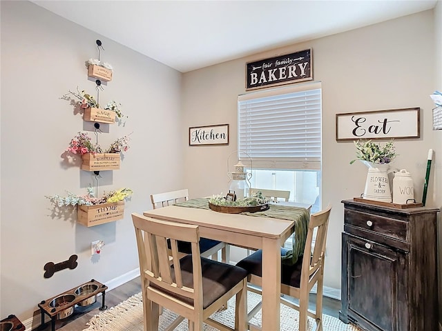 dining area with wood finished floors and baseboards