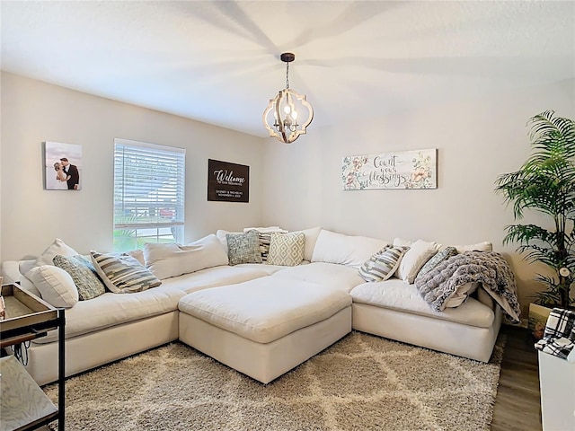 living room with light wood-style flooring and a notable chandelier