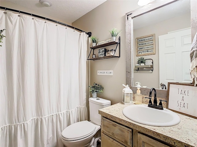 bathroom with toilet and vanity