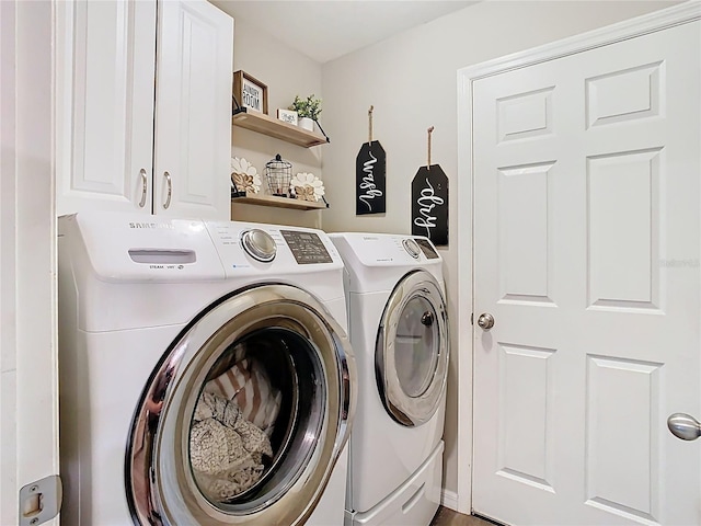 laundry area with washing machine and clothes dryer and cabinet space