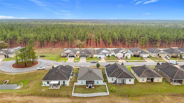 drone / aerial view with a residential view and a view of trees