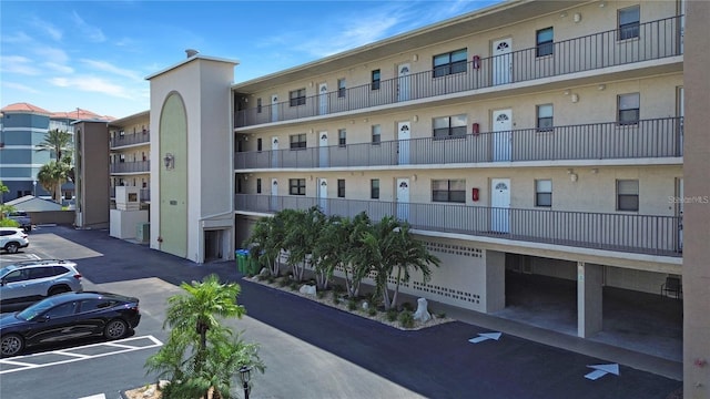 view of building exterior featuring uncovered parking