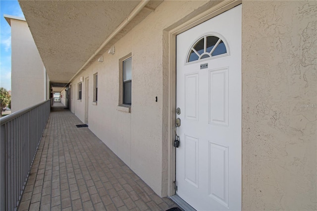 doorway to property with stucco siding