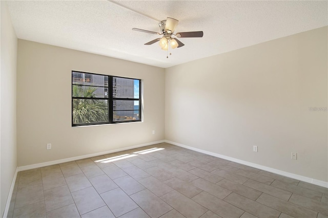 unfurnished room with baseboards, a textured ceiling, and ceiling fan