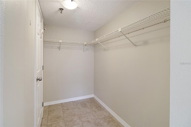 spacious closet featuring light tile patterned floors