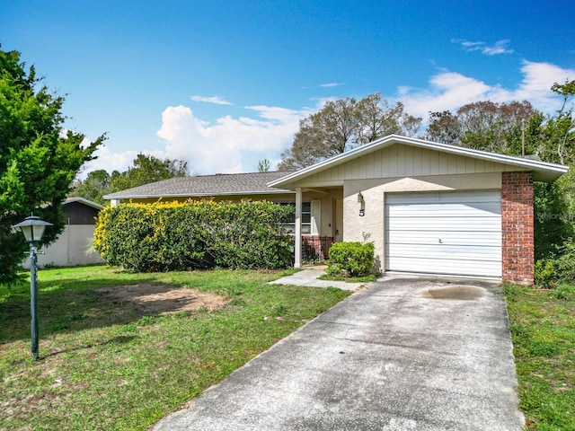 ranch-style house featuring a garage, a front yard, driveway, and stucco siding