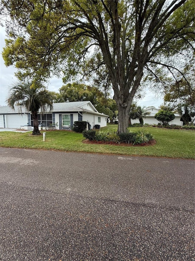 view of front of property with a garage and a front lawn