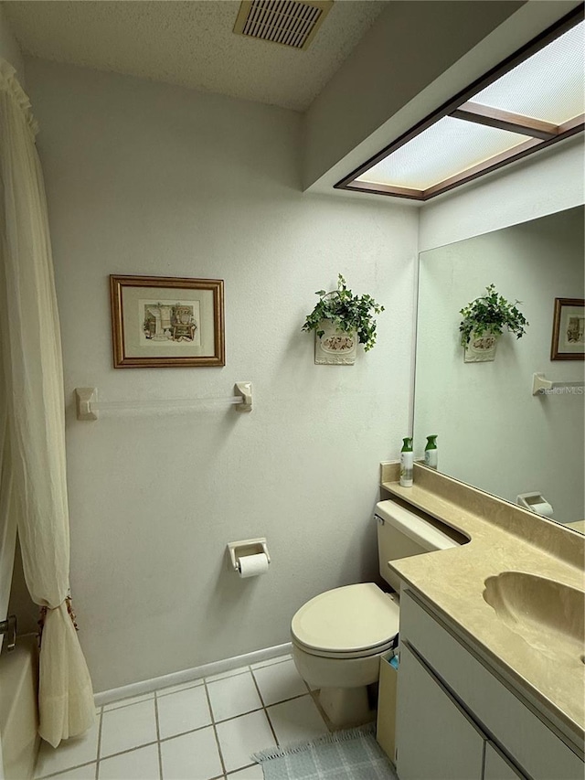 bathroom with visible vents, toilet, vanity, tile patterned floors, and a textured ceiling