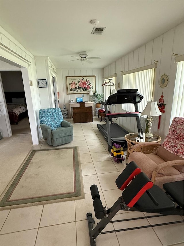 interior space featuring light tile patterned floors, visible vents, and ceiling fan