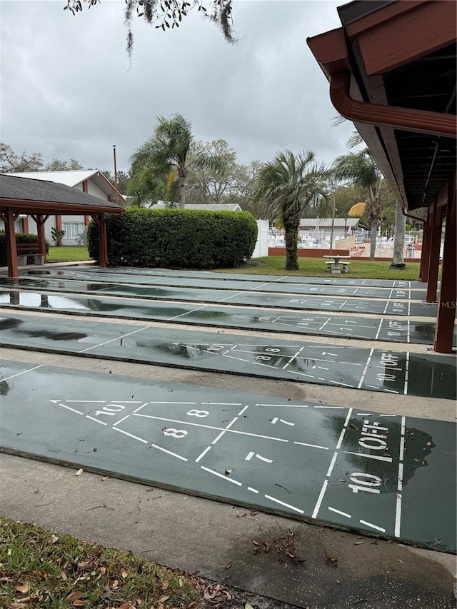 view of home's community featuring shuffleboard