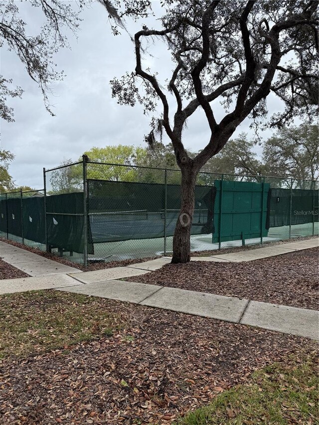 view of sport court featuring fence