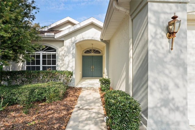 property entrance with stucco siding