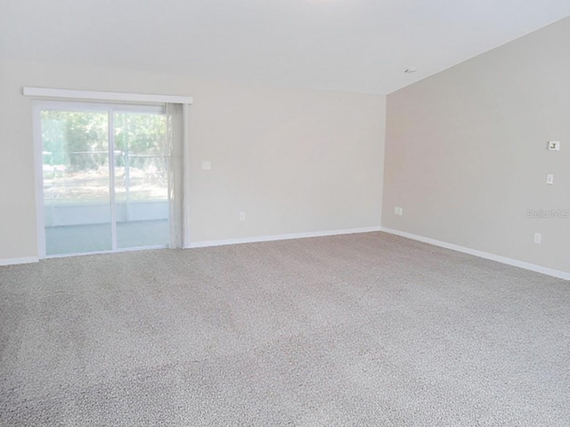 unfurnished room with baseboards and carpet