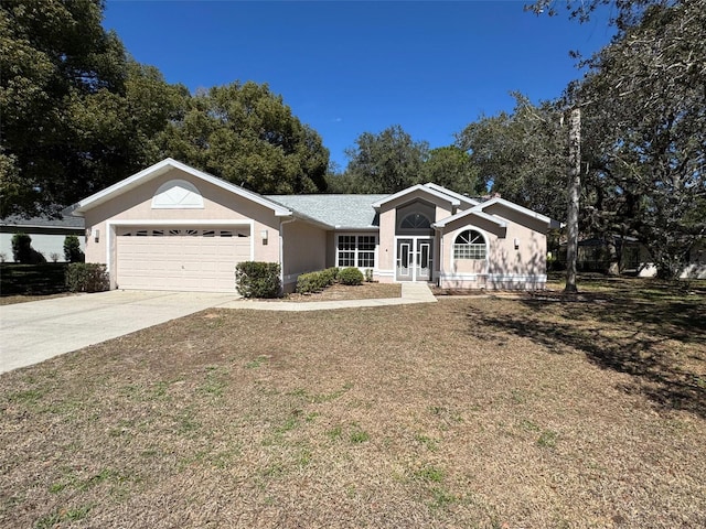 single story home with a garage, concrete driveway, and stucco siding