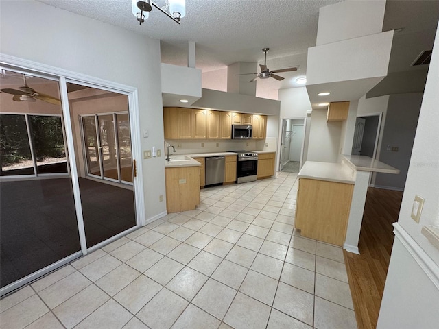 kitchen featuring visible vents, ceiling fan, a sink, light countertops, and appliances with stainless steel finishes