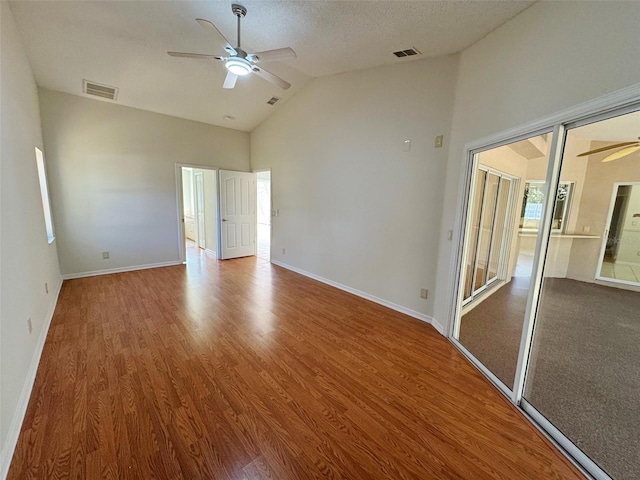 unfurnished bedroom featuring visible vents, ceiling fan, baseboards, and wood finished floors