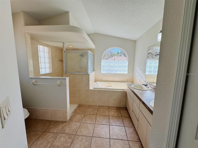 full bath featuring tile patterned flooring, a walk in shower, lofted ceiling, a bath, and a textured ceiling