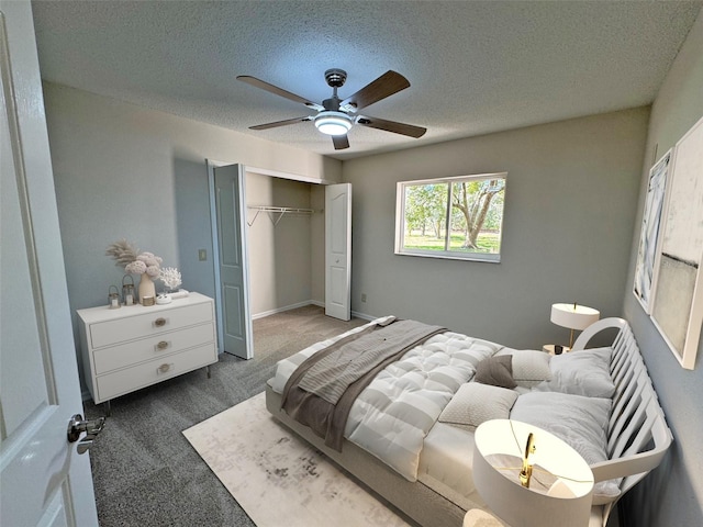 bedroom featuring a textured ceiling, a closet, carpet, baseboards, and ceiling fan