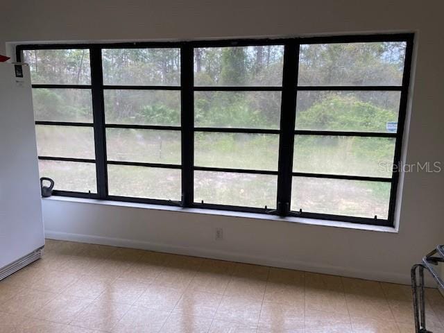 empty room with baseboards and plenty of natural light