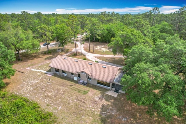 bird's eye view with a wooded view