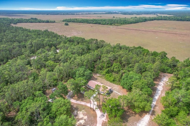 drone / aerial view with a forest view and a rural view