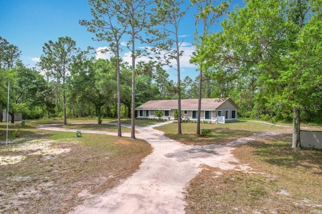 view of front of property with driveway and a front lawn