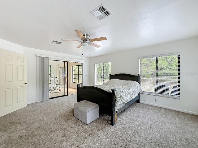 bedroom featuring baseboards, visible vents, ceiling fan, and carpet floors