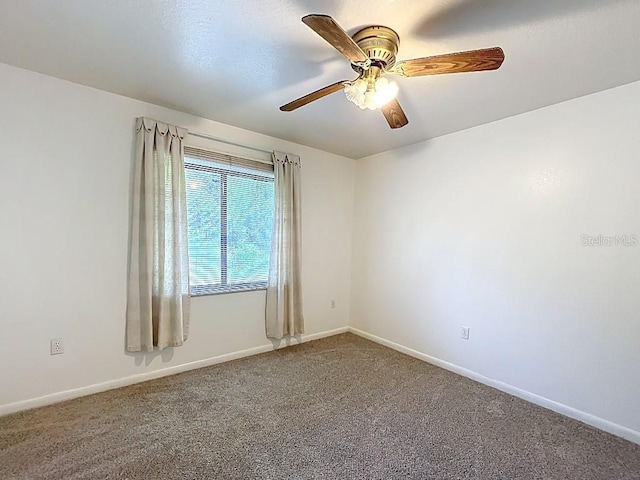 empty room with carpet flooring, baseboards, and ceiling fan